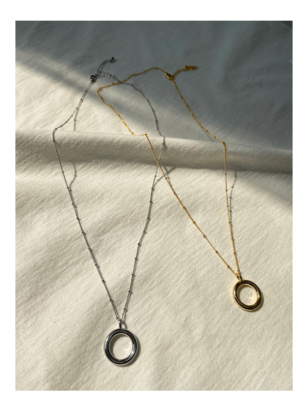 Elegant Circular Pendant Necklace in Gold and Silver